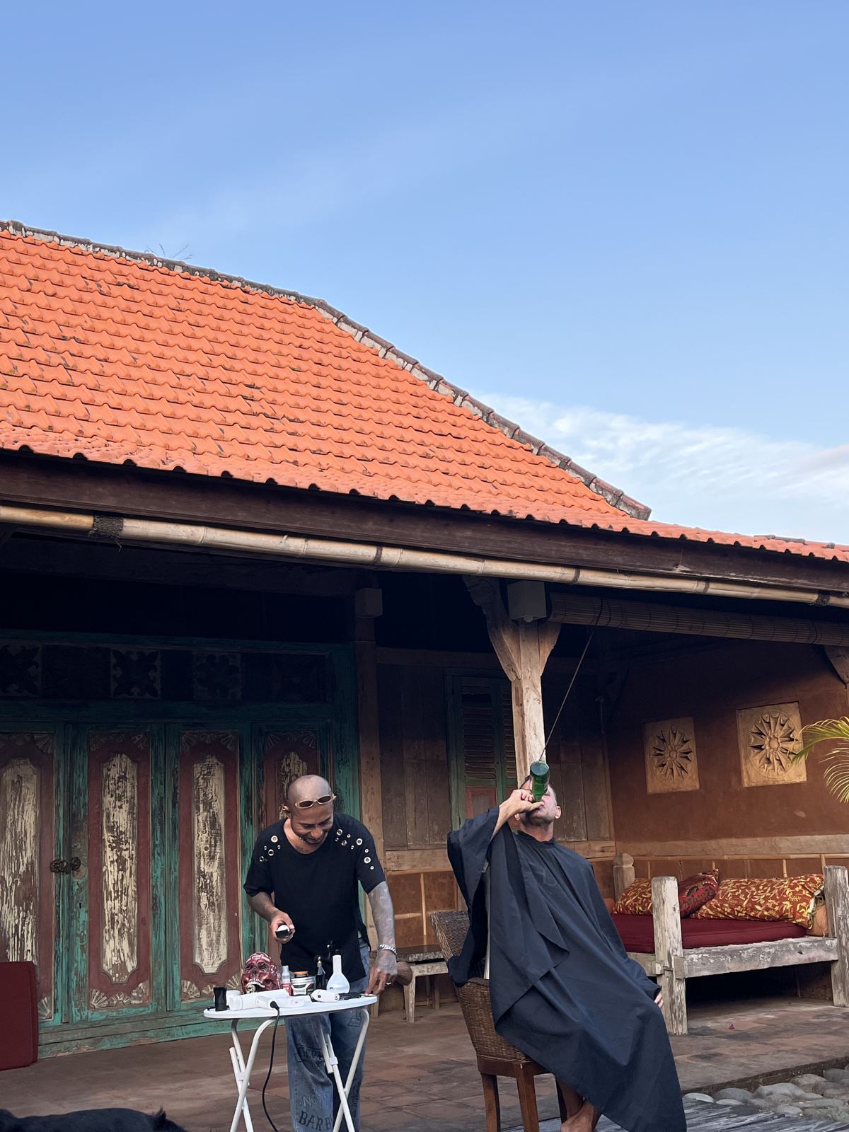 Barber kit set up outside a traditional Balinese pavilion