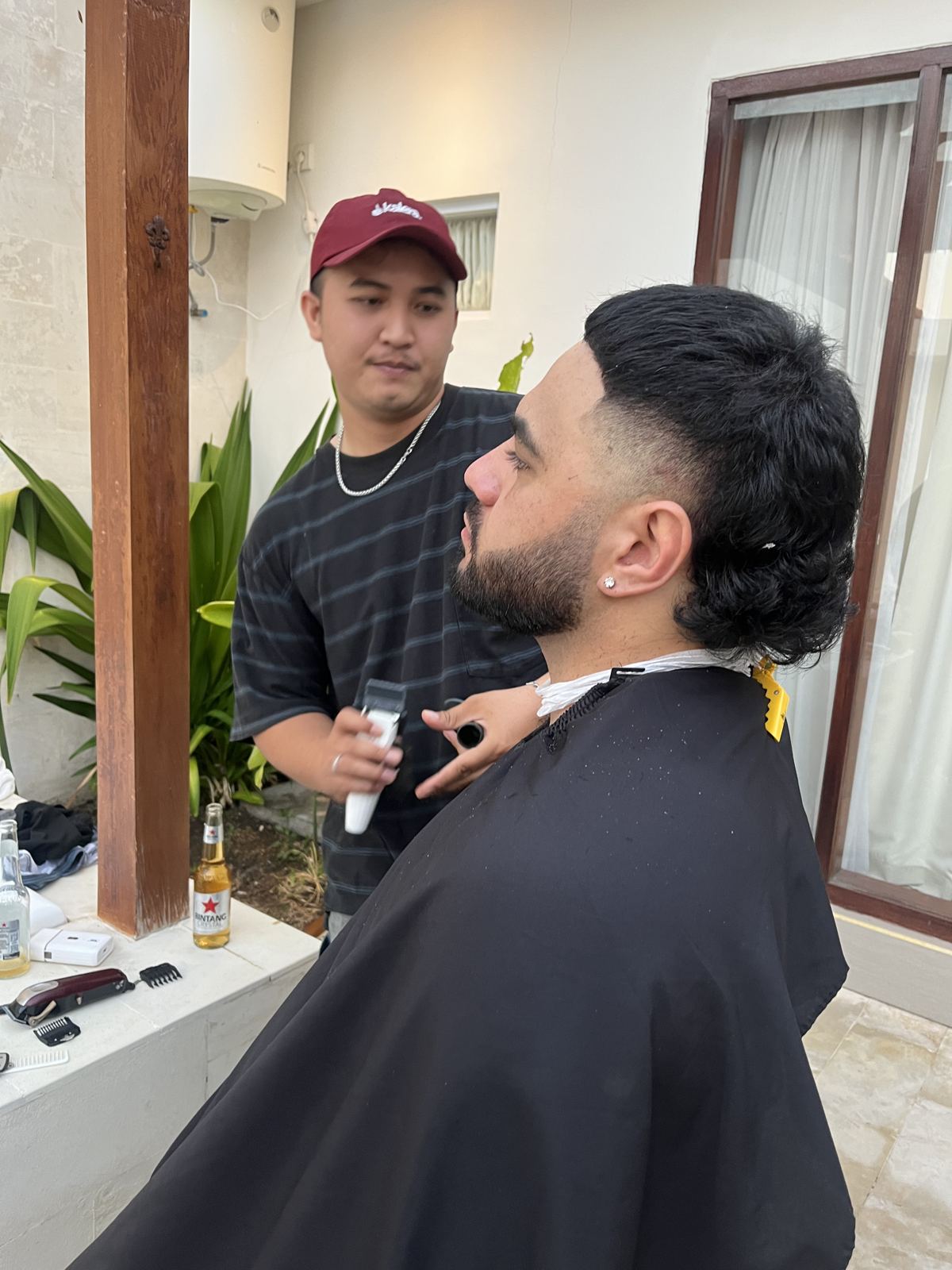 Zan cutting a client's hair on location
